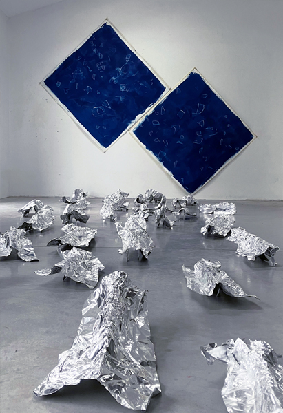 A wall-mounted Artwork with a spacial Artwork in front